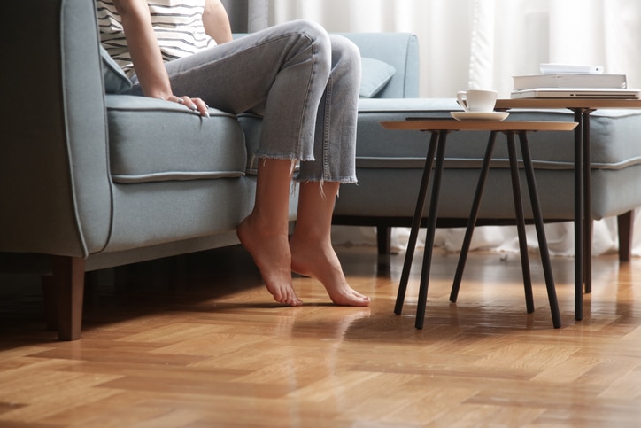 a person sitting on an engineered hardwood floor