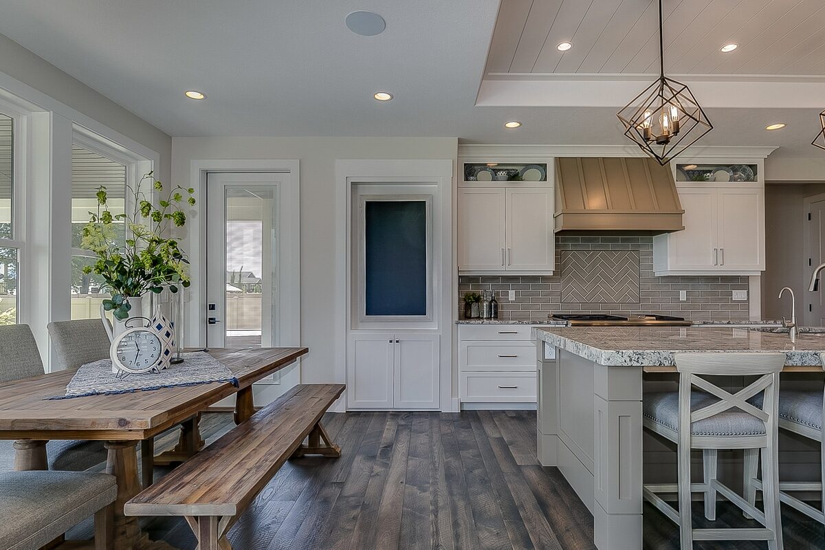 open plan kitchen dining room with dark gray hardwood floors
