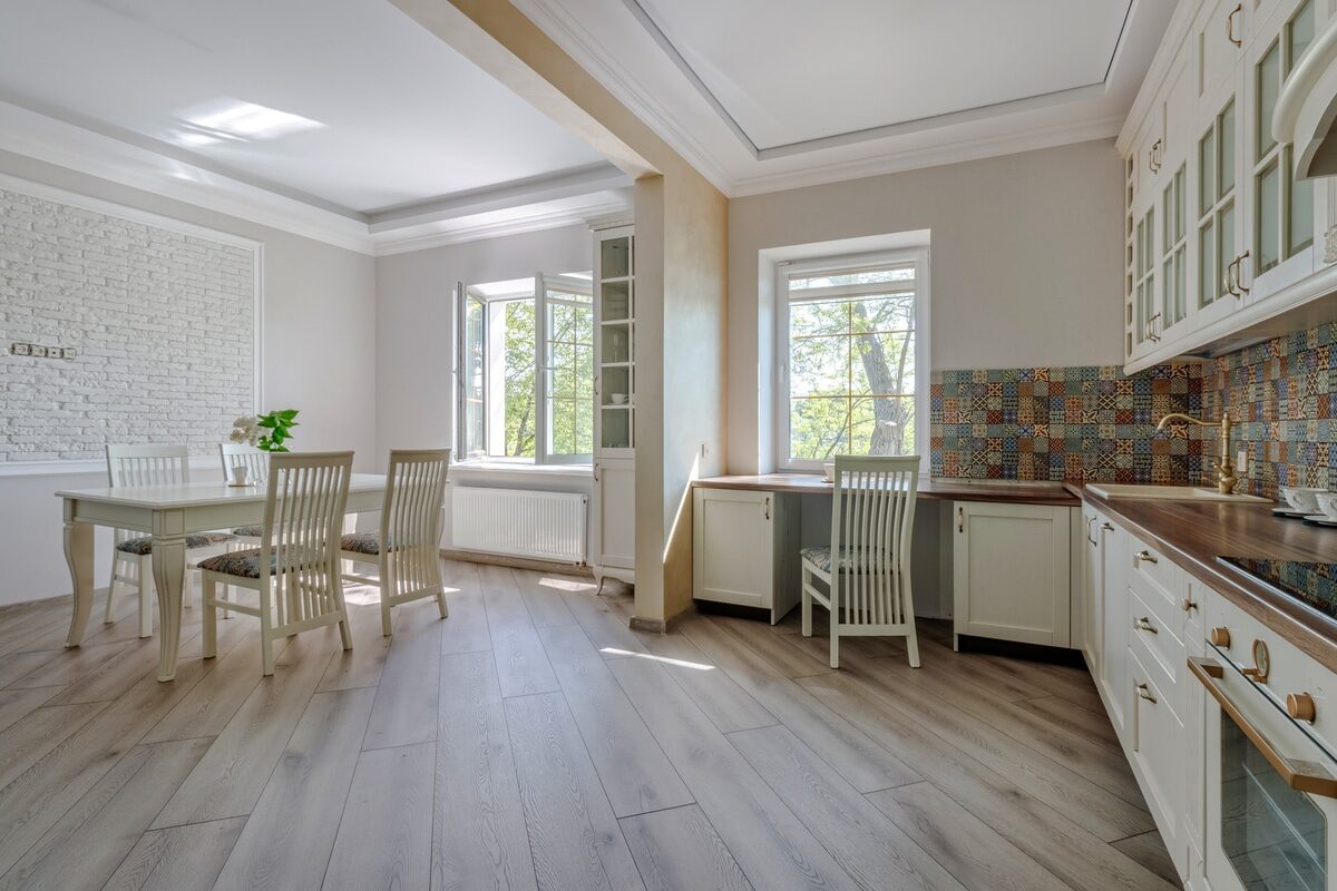 greige hardwood flooring with light colored walls in a kitchen