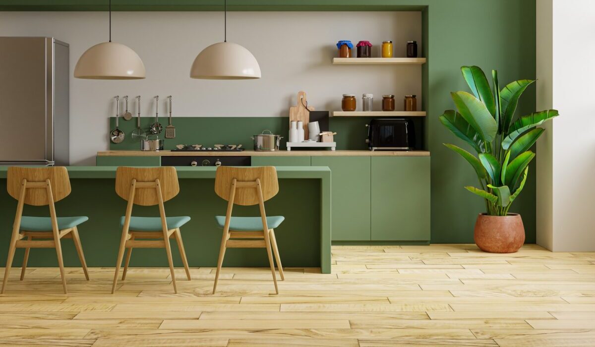 a retro style green kitchen with light hardwood floors