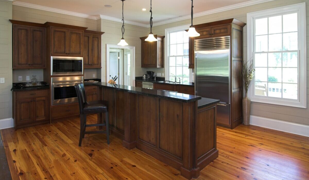 luxury kitchen with dark wood cabinets and knotty hardwood floors