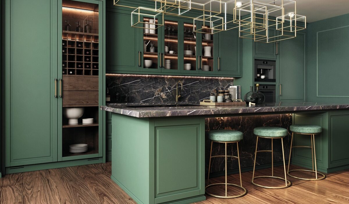 retro green kitchen with marble worktop and dark hardwood floors