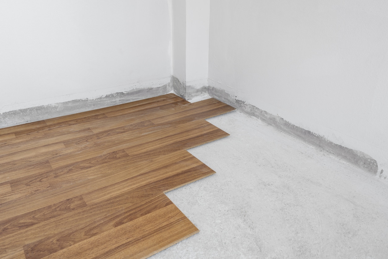 hardwood floor being installed over a concrete slab