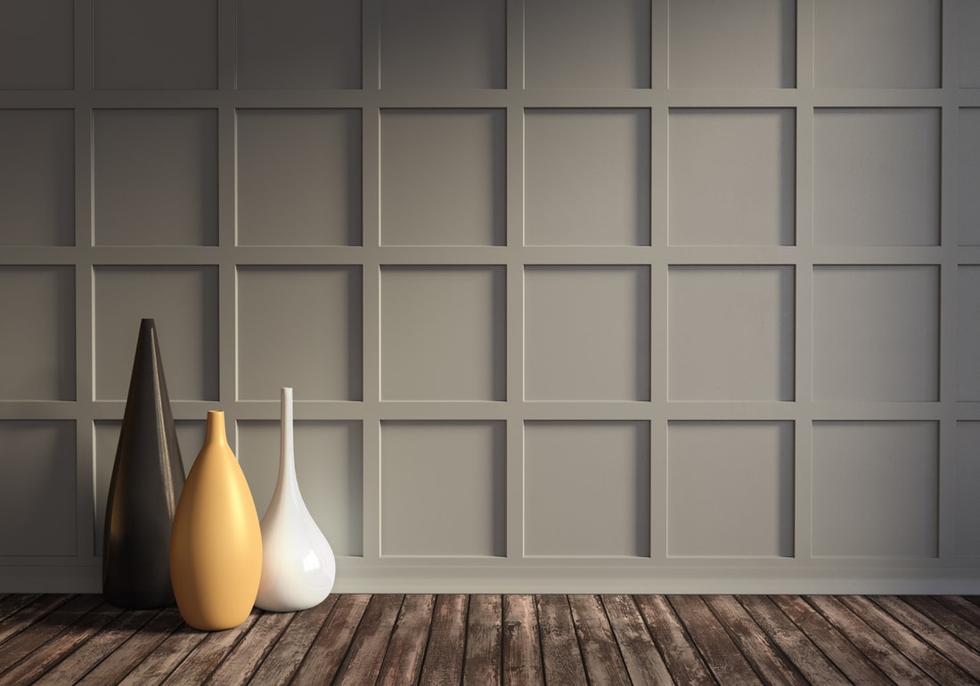 a lounge with gray wall panels and distressed wood floors