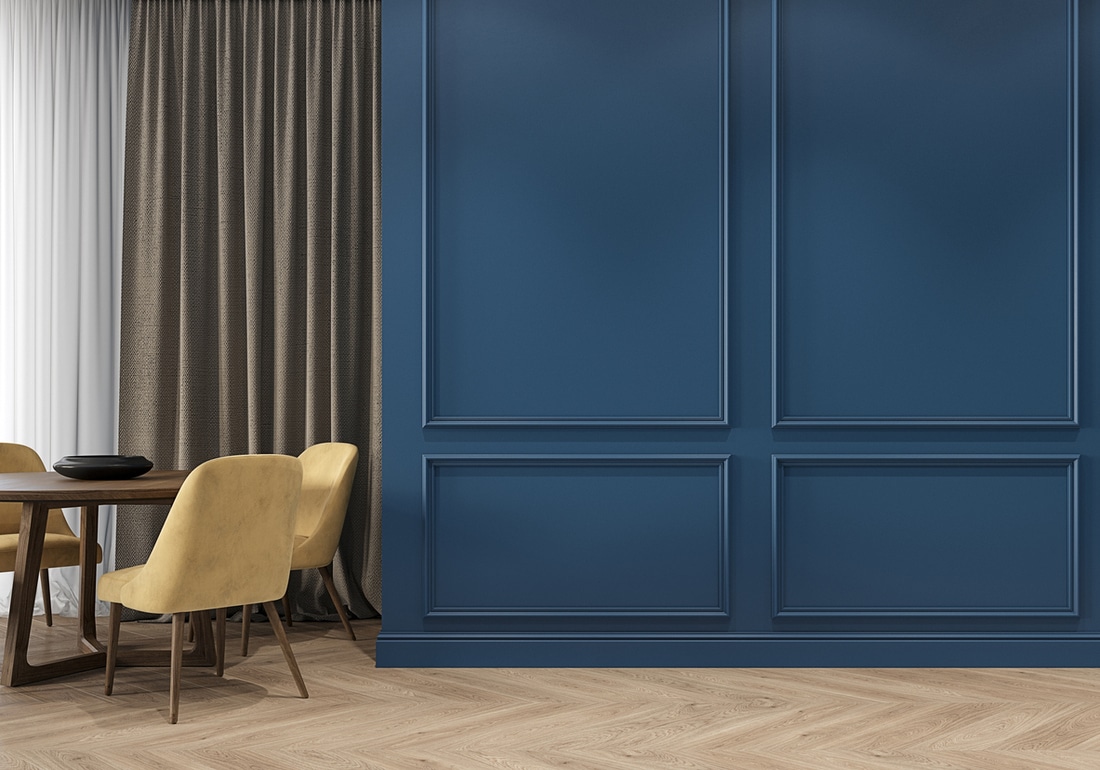a modern lounge with navy wall panels and light wood herringbone floors