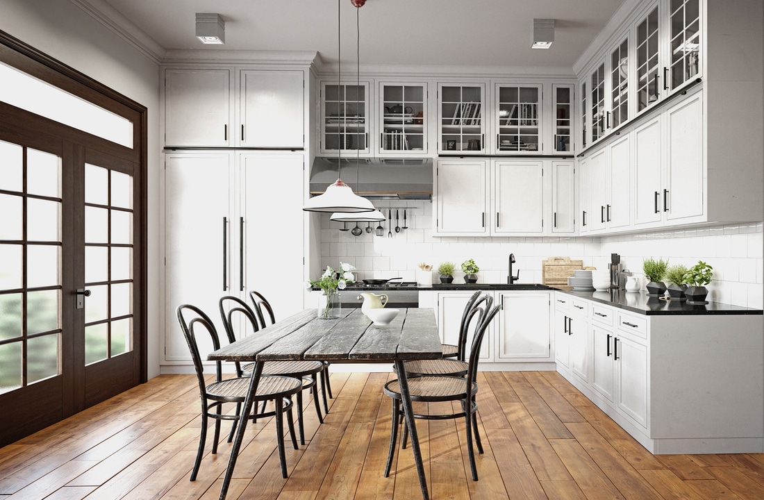 a modern kitchen with dining table and medium wood floors