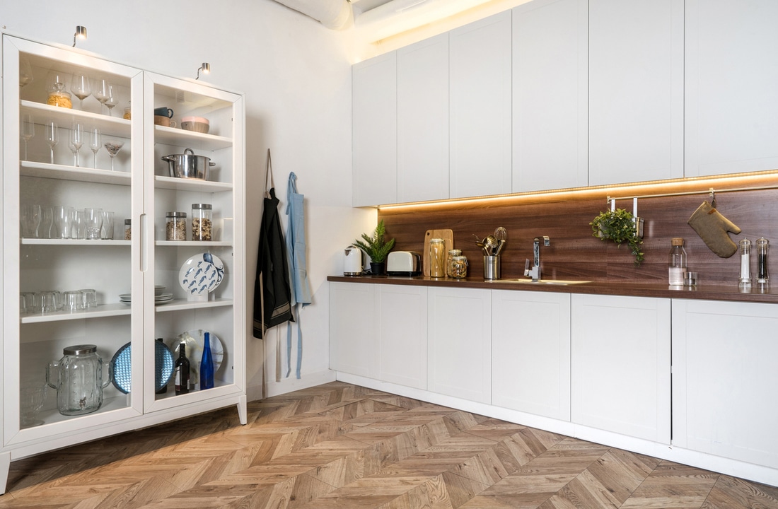 a modern kitchen with herringbone floors