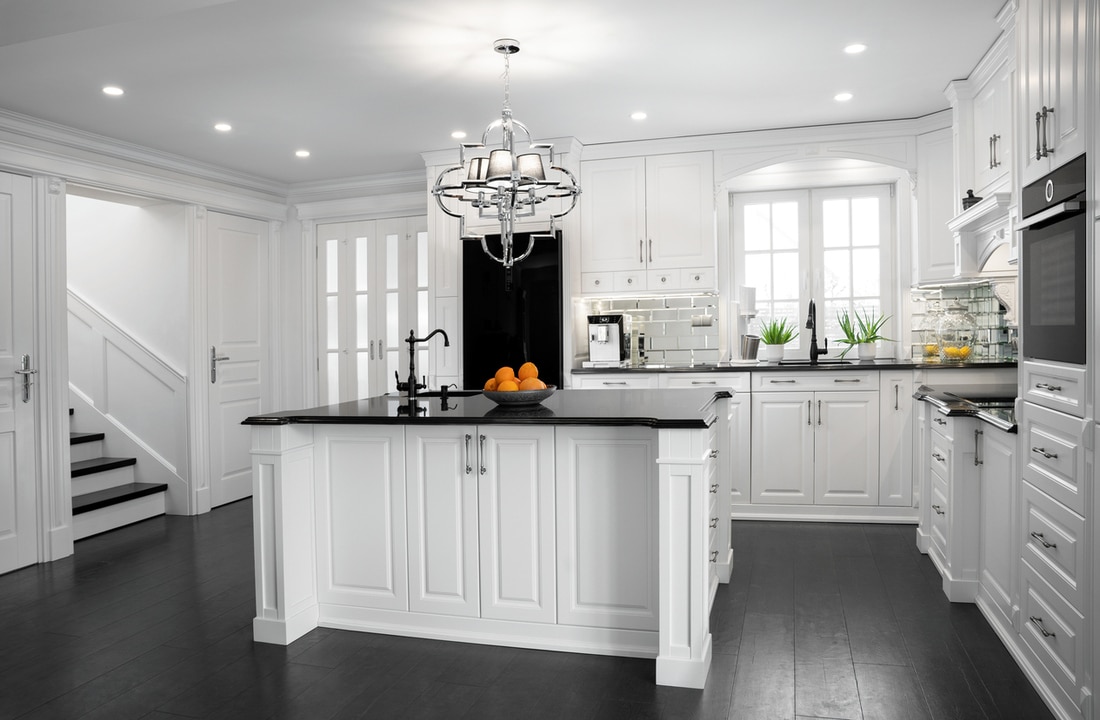 a kitchen with island and black wood flooring