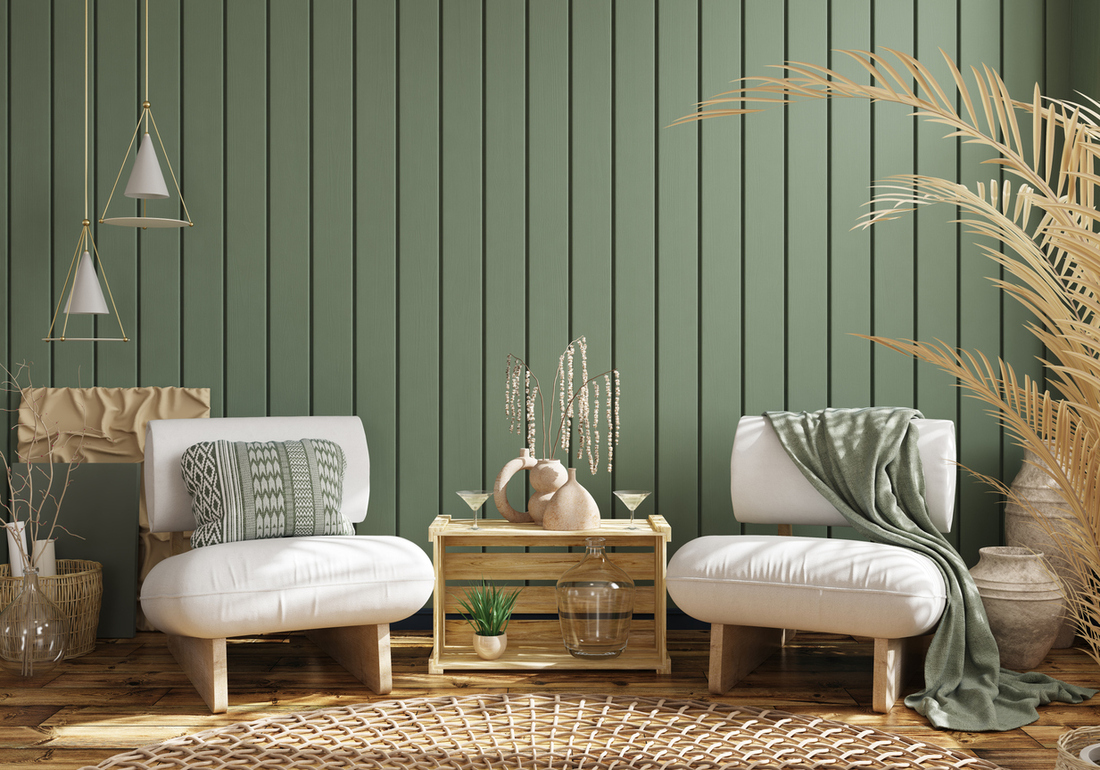 a living room with green plank wall panels and medium brown wood floors