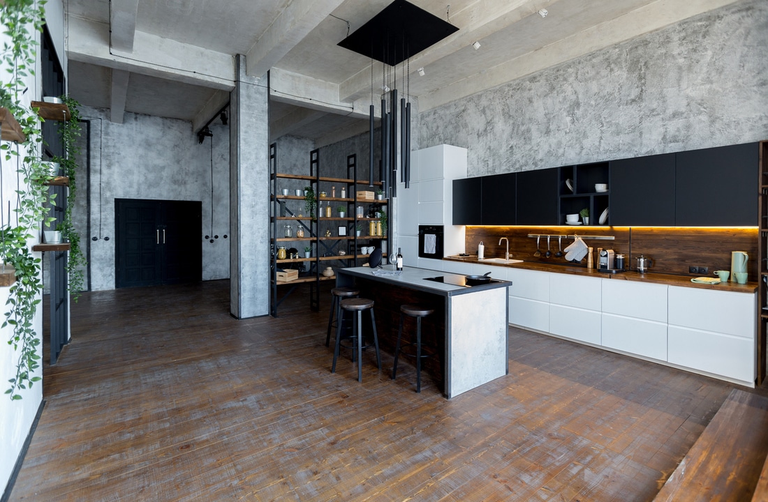 a kitchen with white cabinets and distressed wood floors