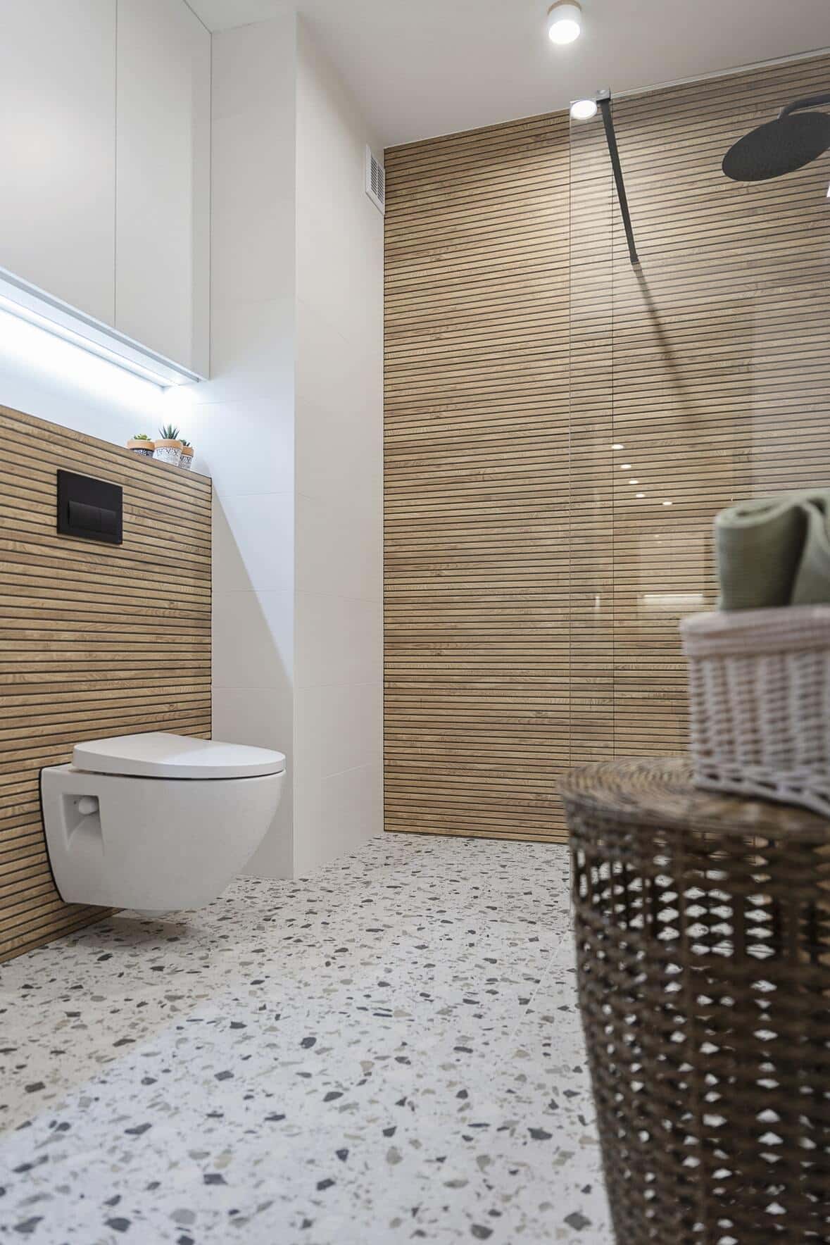 a small bathroom with terrazzo look vinyl floors