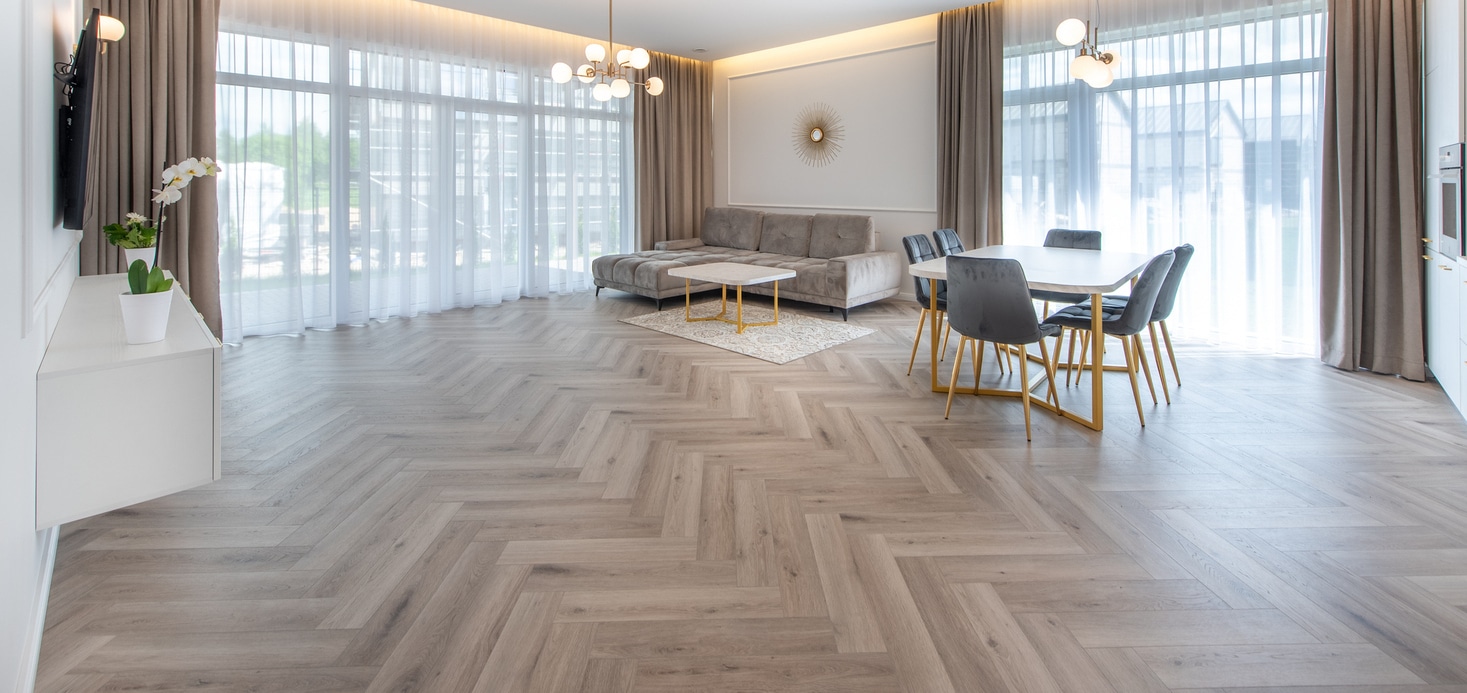 a modern living room with herringbone vinyl plank floor pattern