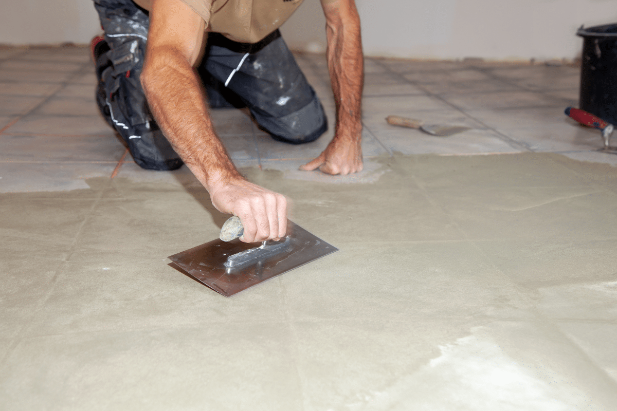 a man levels the subfloor because its preparation is paramount to a successful installation