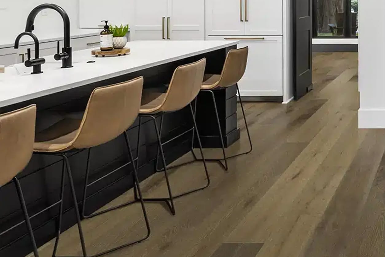 Wide-plank waterproof vinyl flooring in white and black gourmet kitchen
